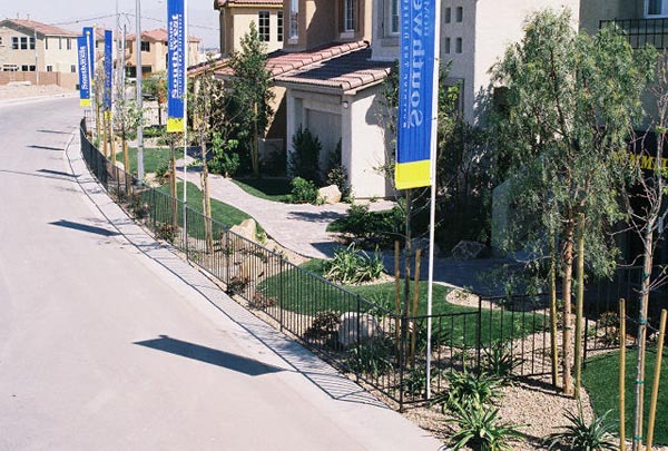 Best artificial lawn front yard landscaping along residential street with decorative iron fencing and desert plants in new home community
