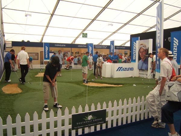 Southwest Greens artificial turf golf course putting and chipping demo area with sand bunkers at Mizuno golf trade show event