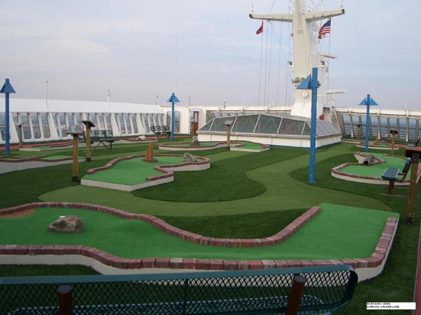 Artificial golf greens mini golf course with brick border edging and ocean views on cruise ship upper deck