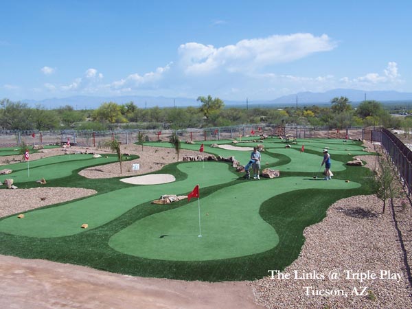 Aerial view of synthetic turf putting green course with sand bunkers and desert landscaping at The Links at Triple Play in Tucson Arizona