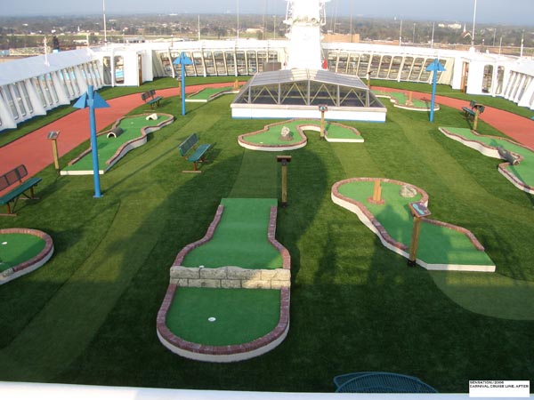Artificial turf mini golf course with multiple holes and obstacles on cruise ship upper deck recreation area