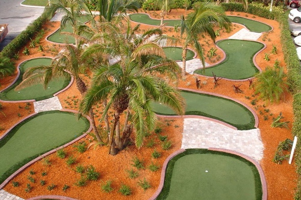 Albuquerque Aerial view of a mini golf course with synthetic grass and palm trees.
