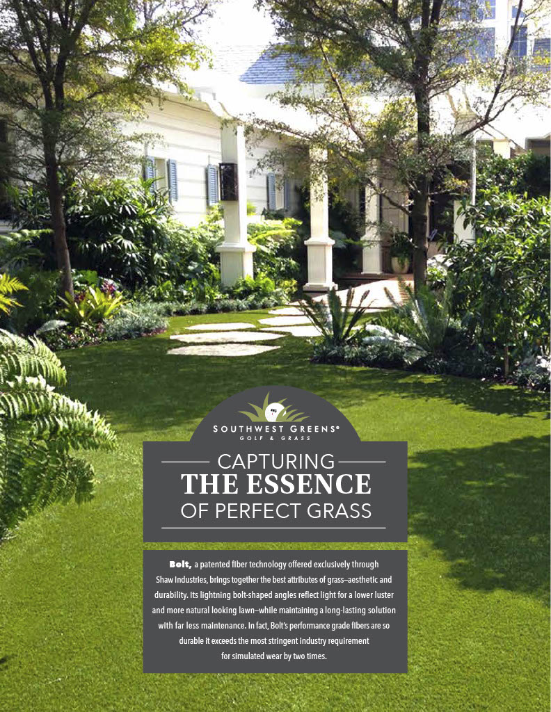 Artificial grass lawn in a beautifully landscaped residential garden with lush greenery, stone pathway, and elegant white home exterior, showcasing realistic synthetic turf for a low-maintenance yard.