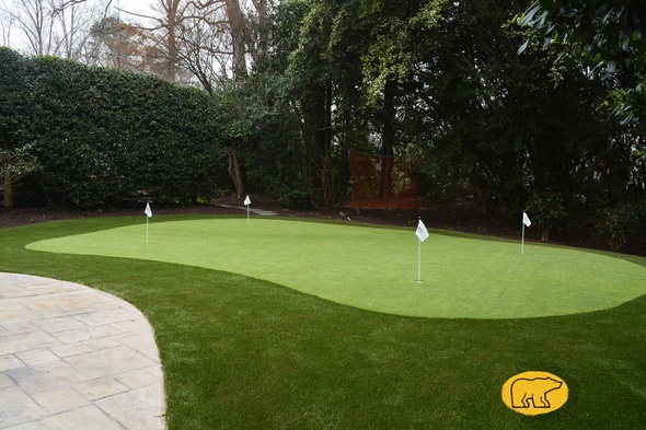 Albuquerque Synthetic grass golf green with 4 holes and flags in a landscaped backyard