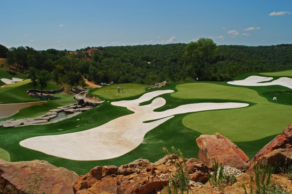 Albuquerque lush green synthetic grass golf course with white sand bunkers and blue sky