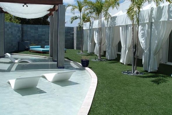 Artificial grass in a backyard  with chairs and a relaxing area